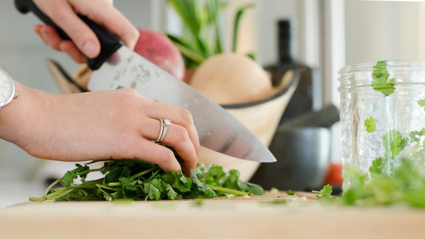 Chef's knife cutting cilantro